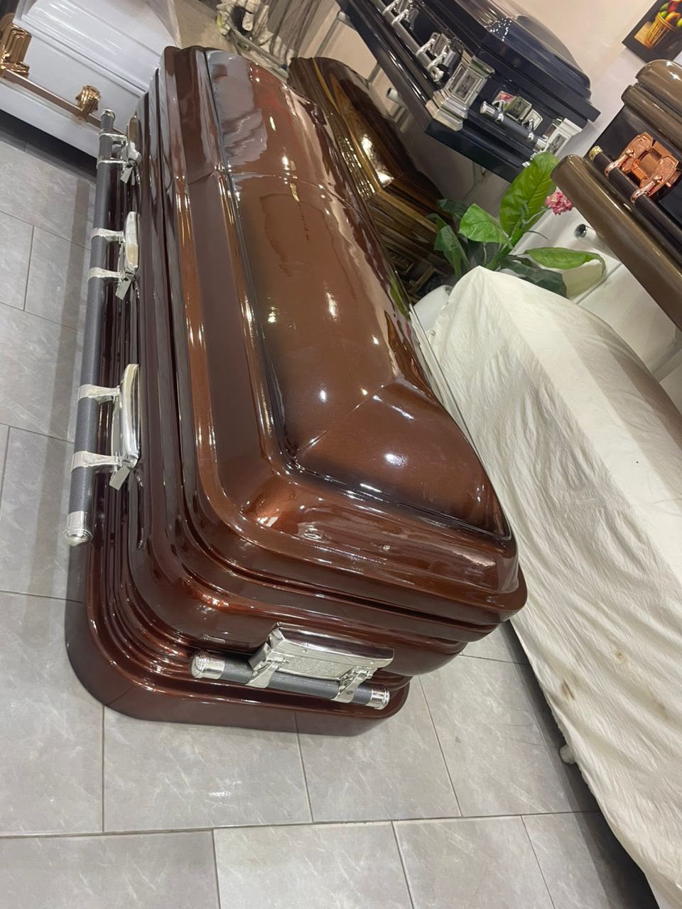 Chestnut brown gloss casket with layered moulding and silver handles