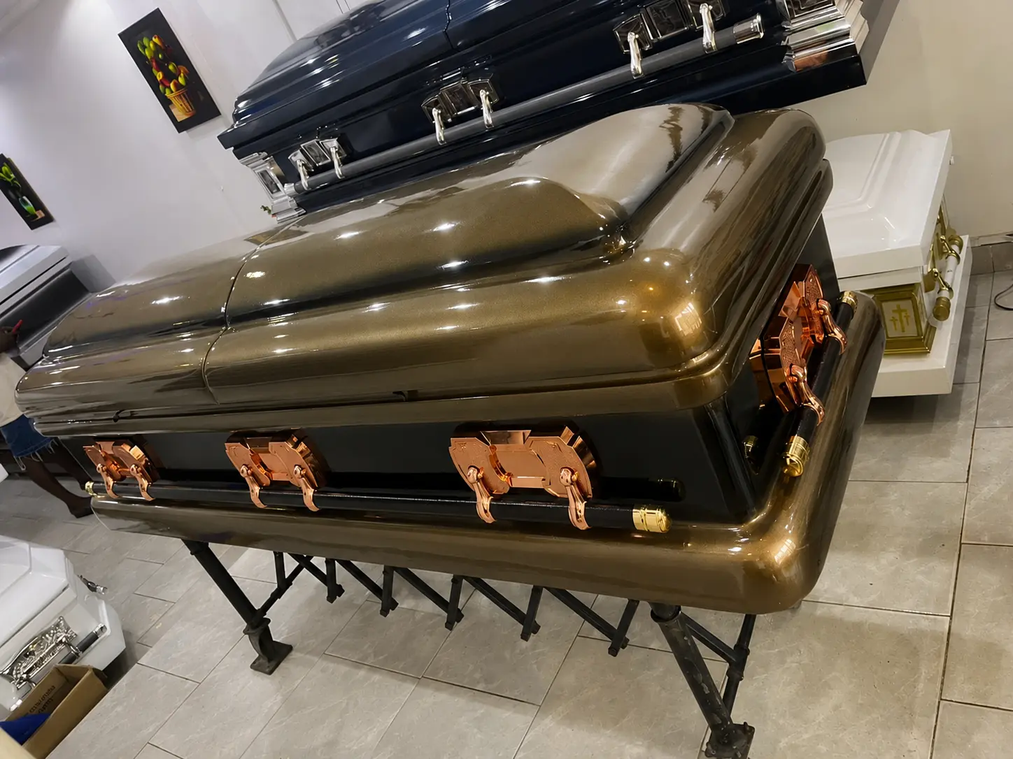 Olive bronze metallic casket with rose gold hardware and black bar handles