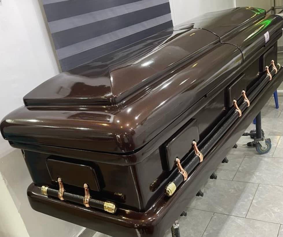 Dark wood-finish casket with copper-tone handles