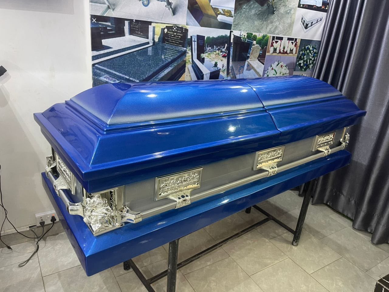 Gloss royal-blue casket with ornate silver-tone hardware