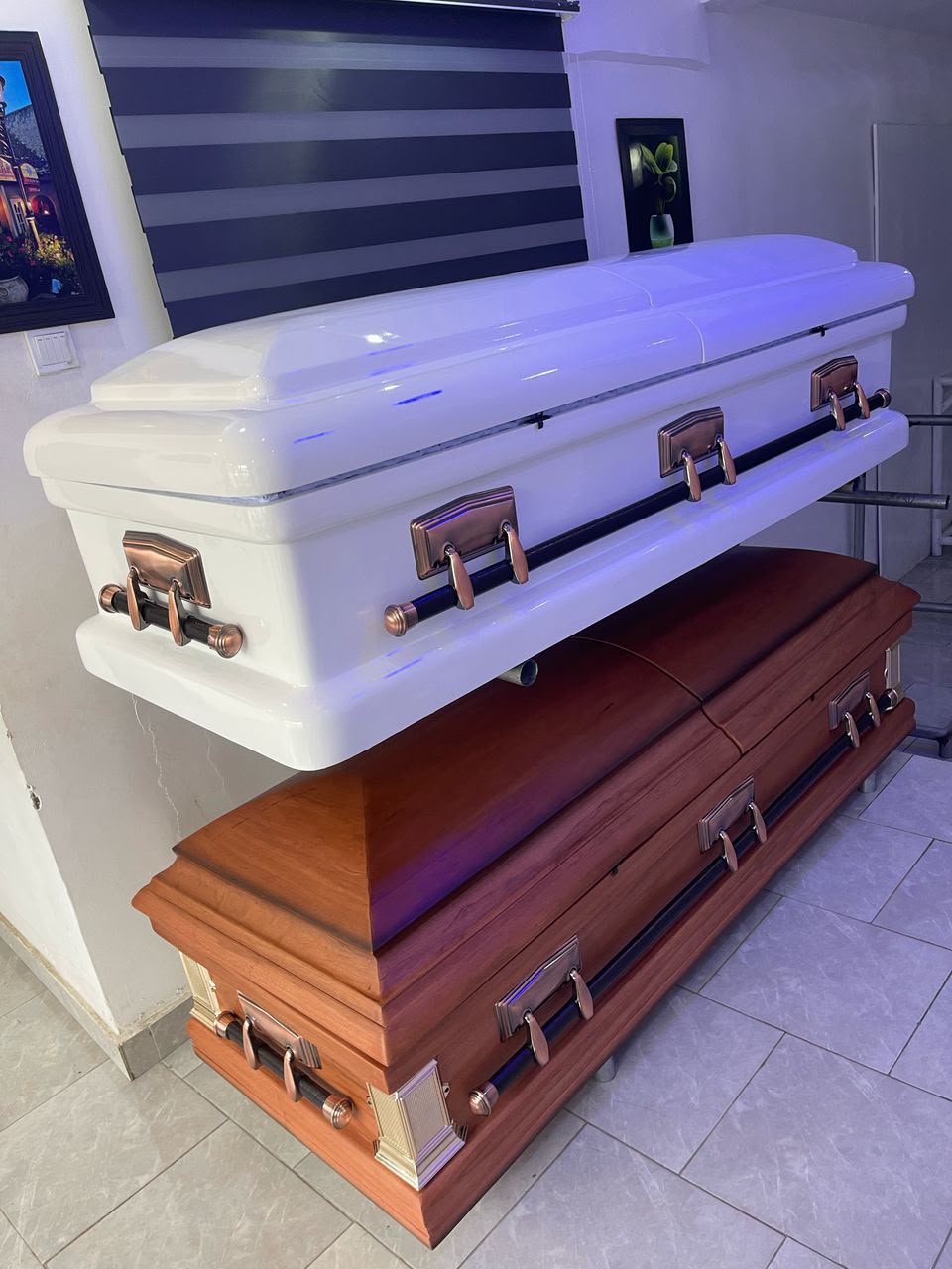 White and oak caskets displayed in the MJ Rosaries showroom