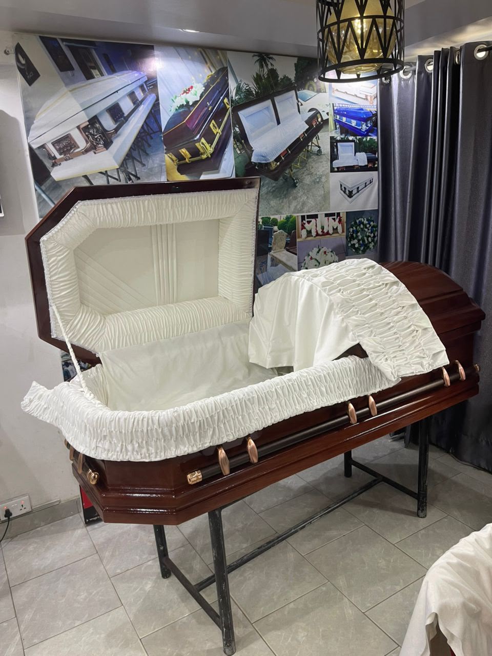Octagonal mahogany casket open with cream ruched interior