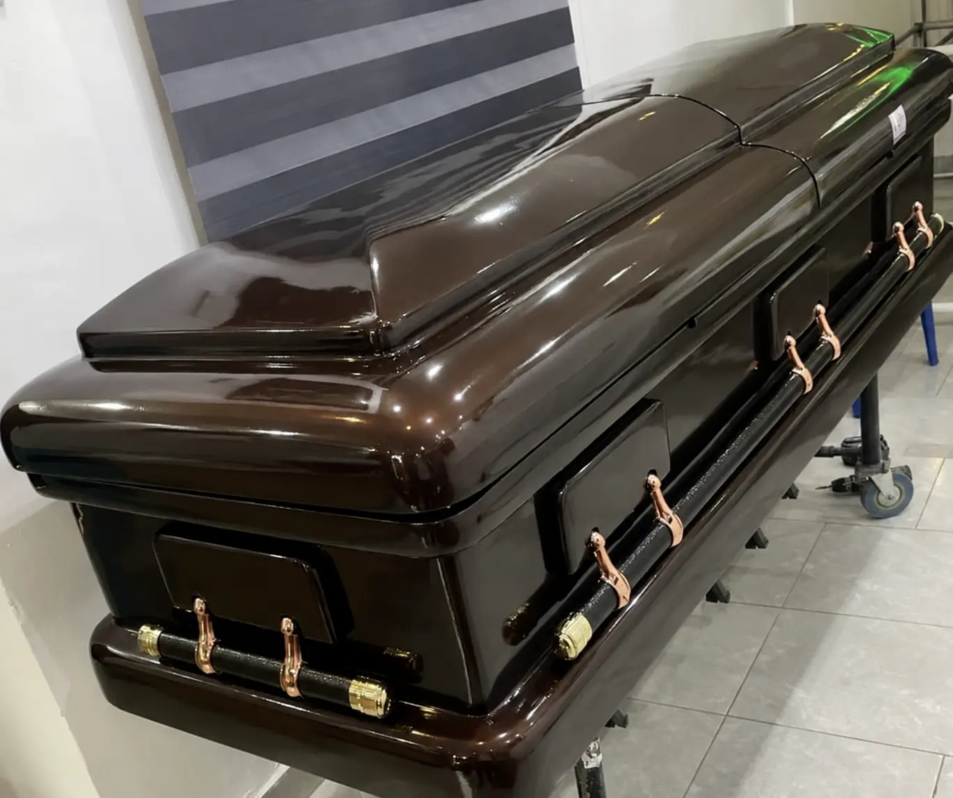 Espresso brown gloss casket with rose gold and black bar handles