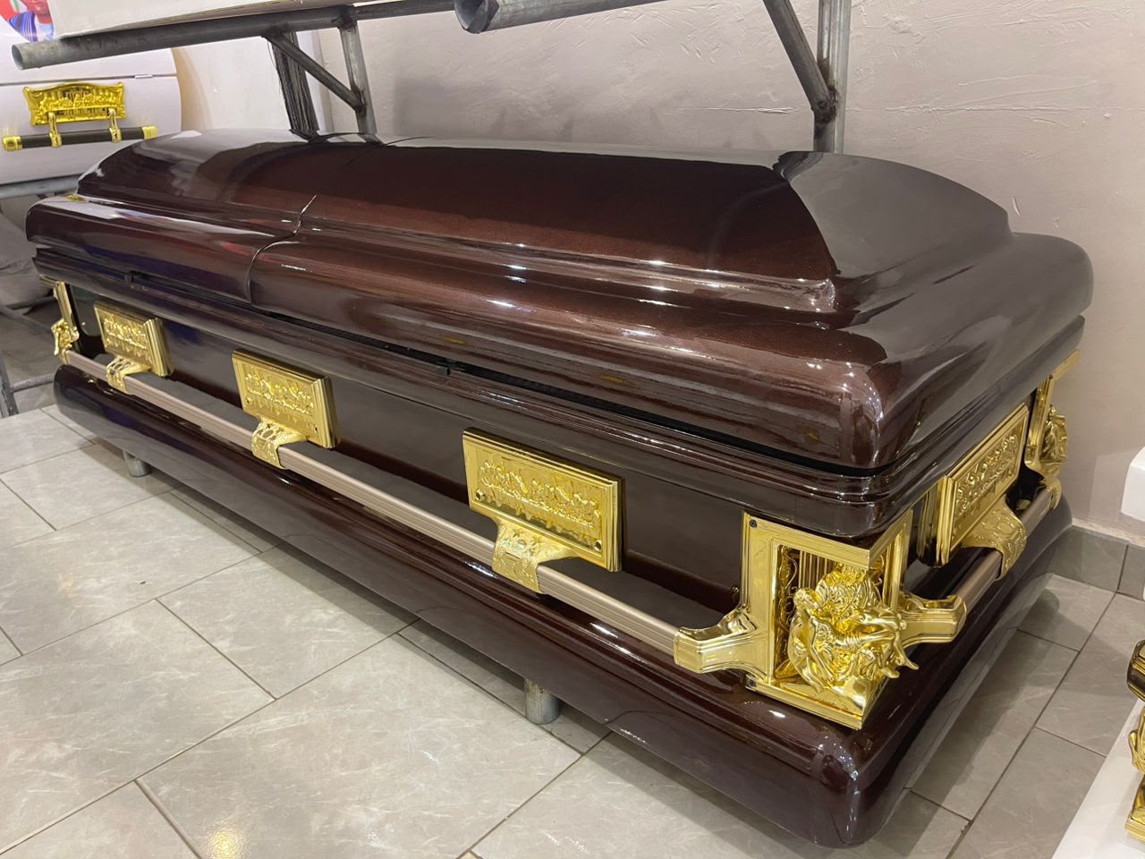 Dark wood-finish casket with ornamental gold-tone handles