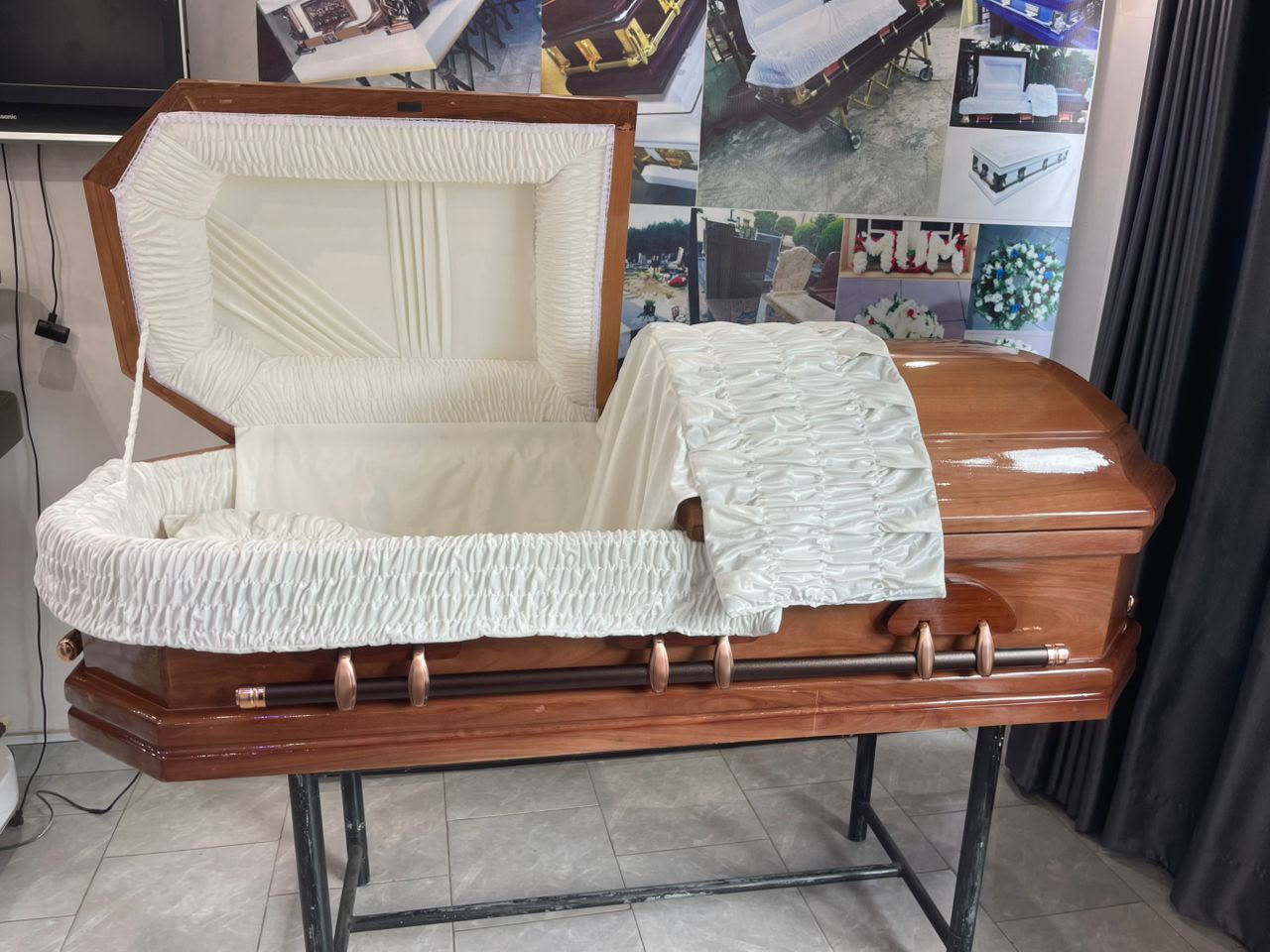 Open cherry wood casket with ivory quilted interior