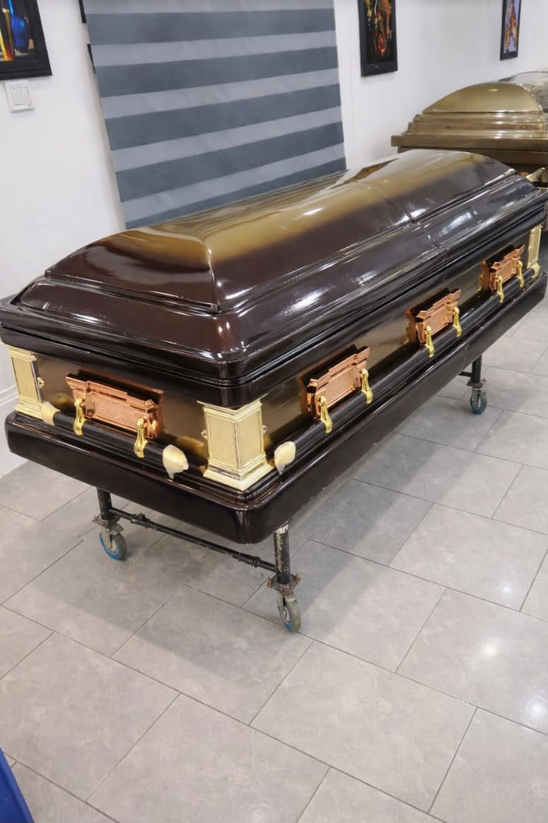 Two-tone espresso and bronze casket with gold corner columns and rose-gold handles