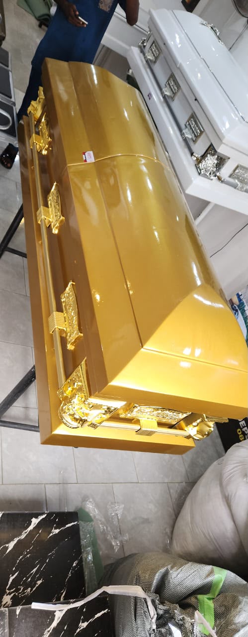 Full gold high-gloss casket with gold ornamental handles