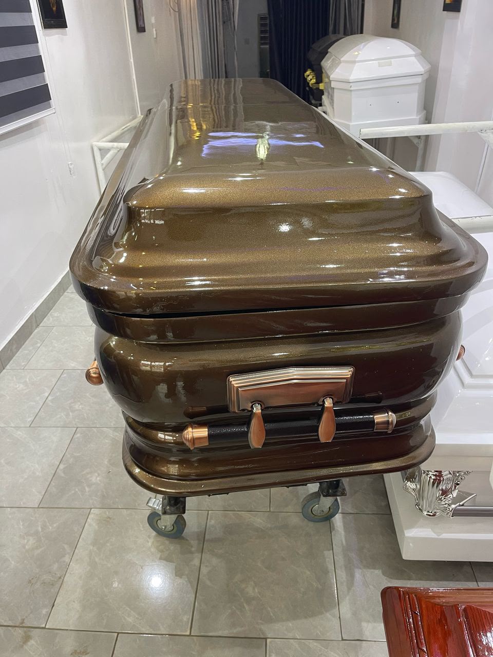 Bronze metallic dome casket on a church truck