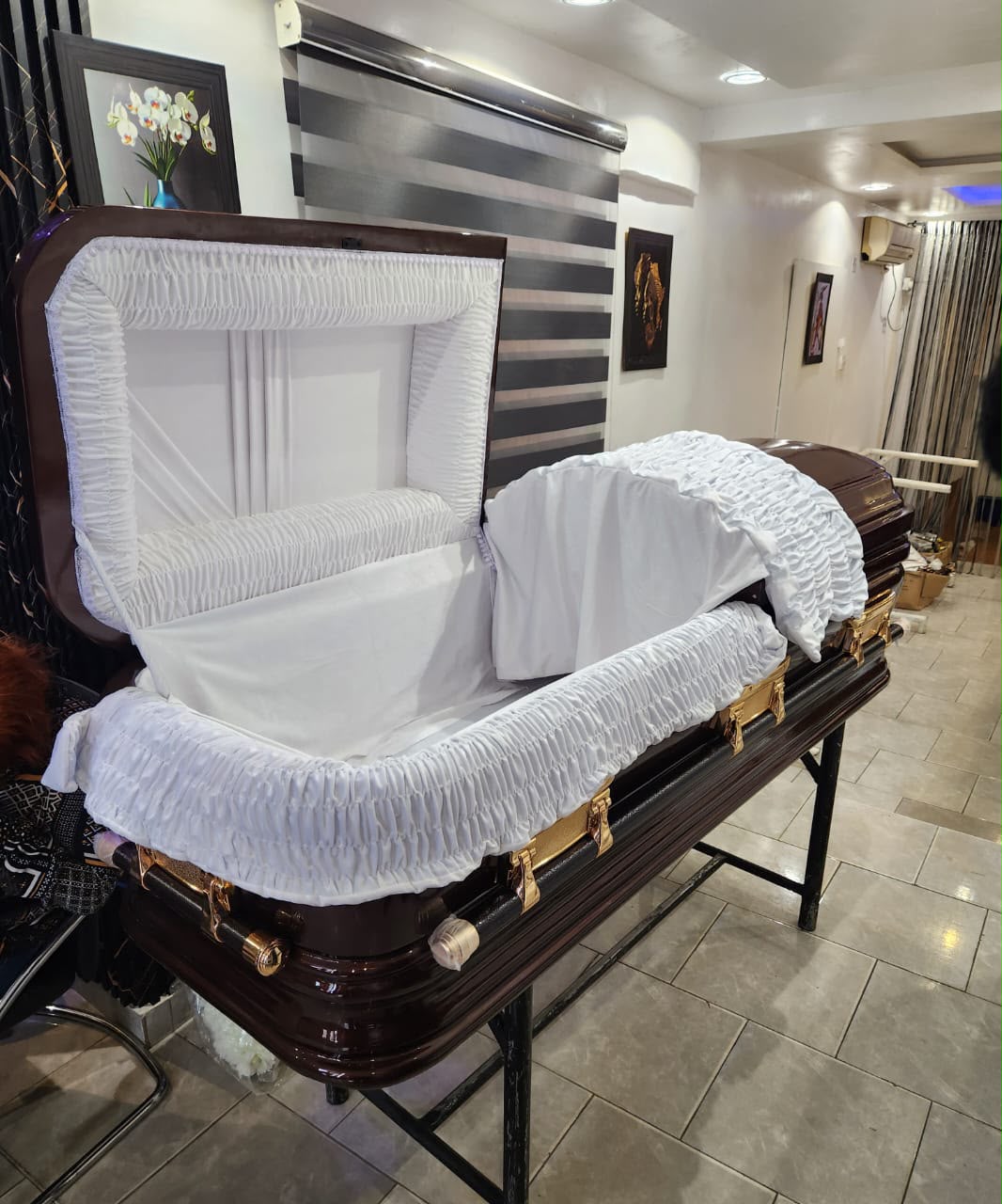 Open dark wood-finish casket with a white ruched interior and overlay